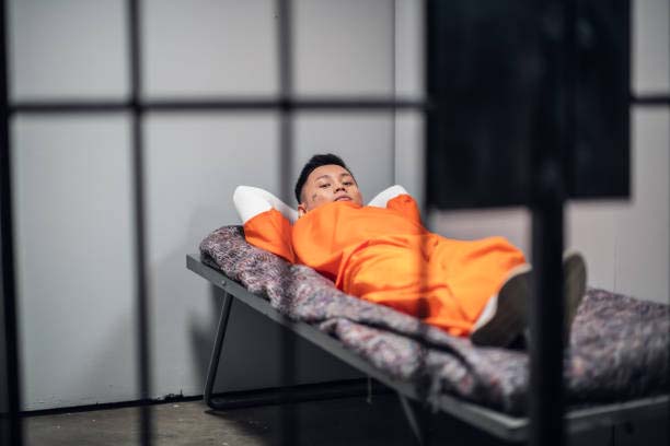 a young prisoner sleeping in his cell