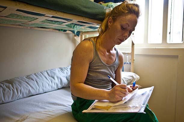 an female inmate writing a letter