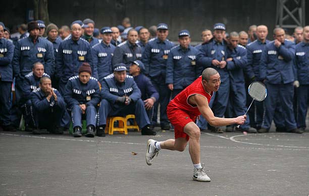 an inmate playing badminton in the prison